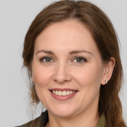 Joyful white adult female with long  brown hair and brown eyes