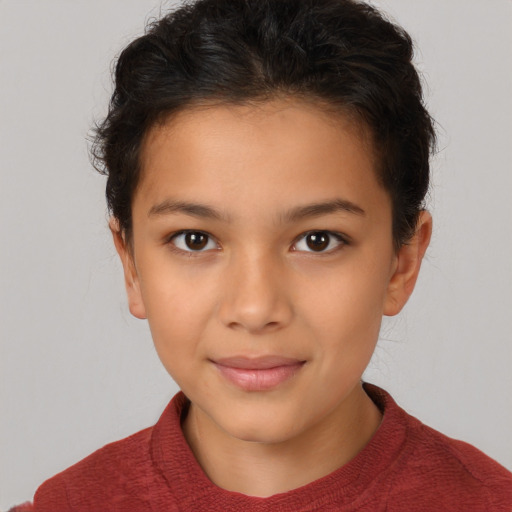 Joyful latino child female with short  brown hair and brown eyes