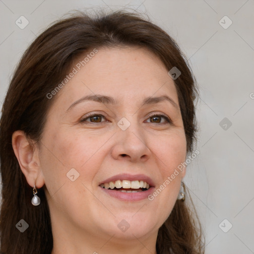 Joyful white adult female with long  brown hair and grey eyes