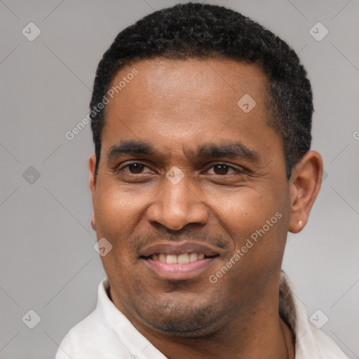 Joyful latino adult male with short  black hair and brown eyes