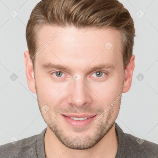 Joyful white young-adult male with short  brown hair and grey eyes