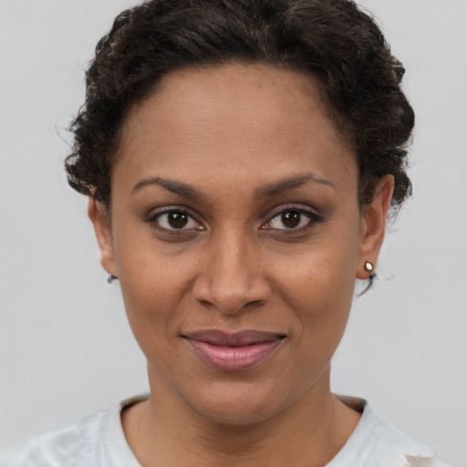 Joyful latino young-adult female with short  brown hair and brown eyes