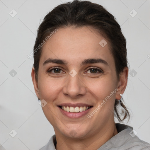 Joyful white young-adult female with short  brown hair and brown eyes