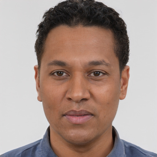 Joyful white adult male with short  black hair and brown eyes