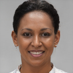 Joyful black young-adult female with short  brown hair and brown eyes