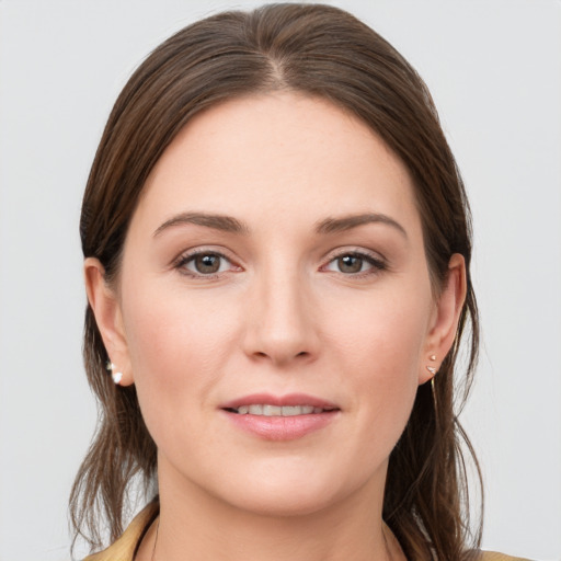 Joyful white young-adult female with medium  brown hair and grey eyes