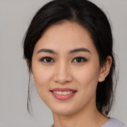 Joyful asian young-adult female with medium  brown hair and brown eyes