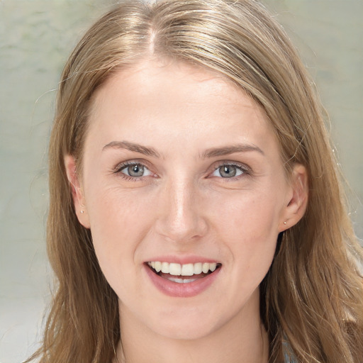 Joyful white young-adult female with long  brown hair and blue eyes