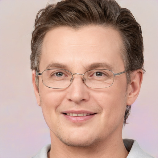 Joyful white adult male with short  brown hair and grey eyes