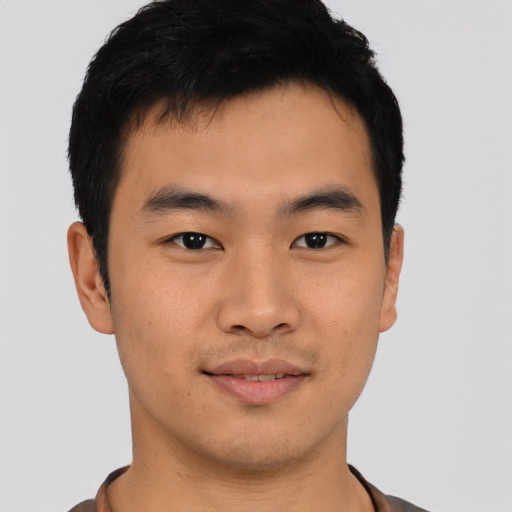 Joyful asian young-adult male with short  black hair and brown eyes