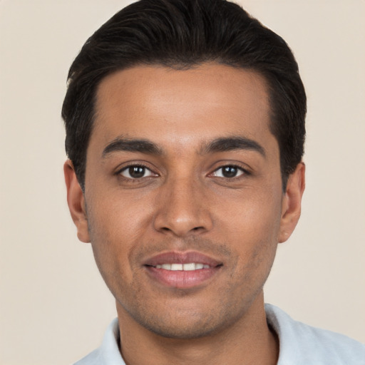 Joyful white young-adult male with short  black hair and brown eyes