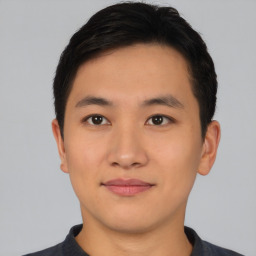 Joyful asian young-adult male with short  black hair and brown eyes