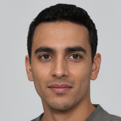 Neutral latino young-adult male with short  black hair and brown eyes