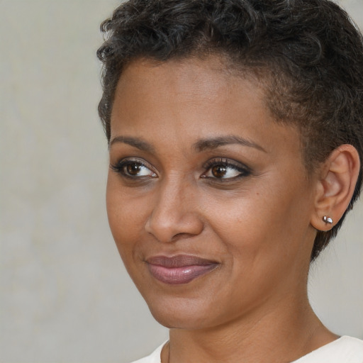Joyful black young-adult female with short  brown hair and brown eyes