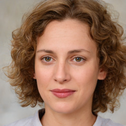 Joyful white young-adult female with medium  brown hair and green eyes