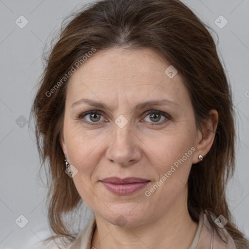 Joyful white adult female with medium  brown hair and grey eyes