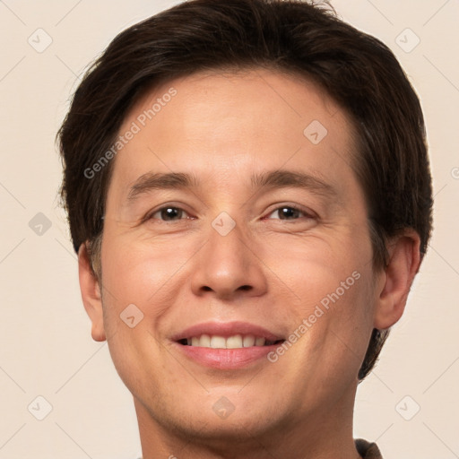 Joyful white adult male with short  brown hair and brown eyes