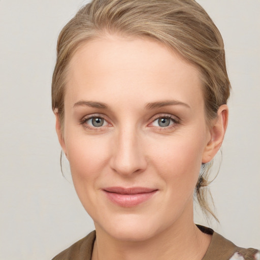 Joyful white young-adult female with medium  brown hair and blue eyes