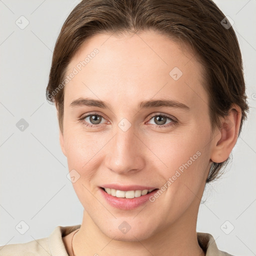 Joyful white young-adult female with short  brown hair and grey eyes