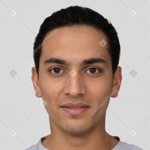 Joyful latino young-adult male with short  black hair and brown eyes