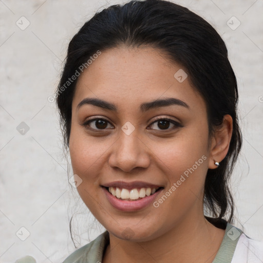 Joyful latino young-adult female with medium  brown hair and brown eyes