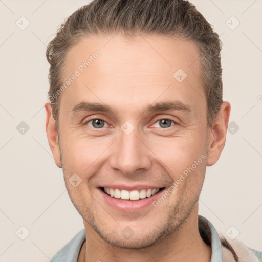 Joyful white young-adult male with short  brown hair and brown eyes