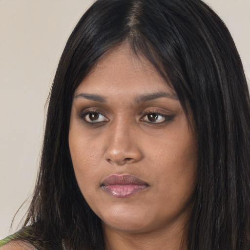 Joyful asian young-adult female with long  black hair and brown eyes