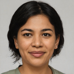 Joyful asian young-adult female with medium  brown hair and brown eyes