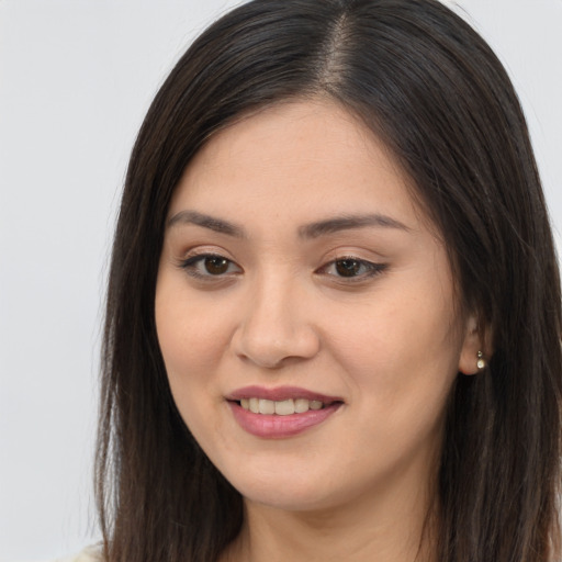 Joyful asian young-adult female with long  brown hair and brown eyes