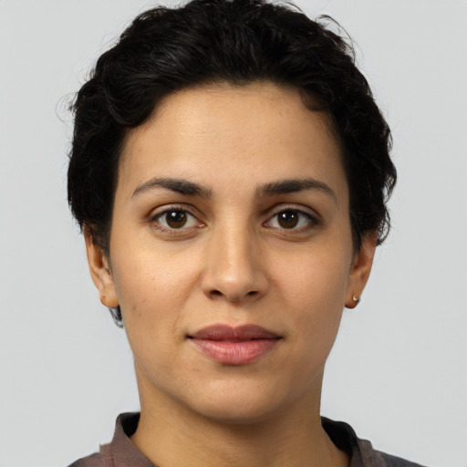 Joyful latino young-adult female with short  brown hair and brown eyes