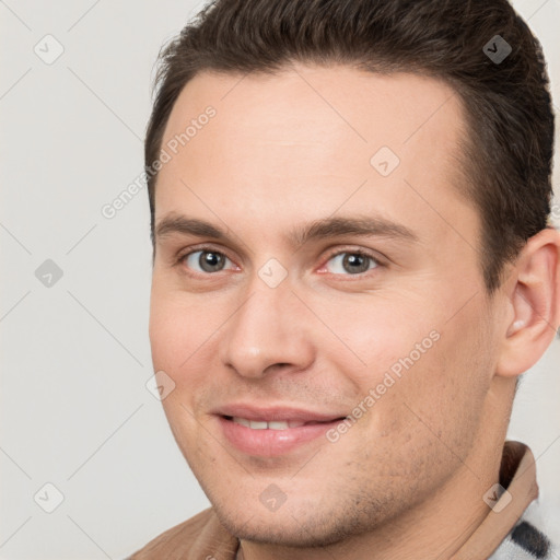 Joyful white young-adult male with short  brown hair and brown eyes