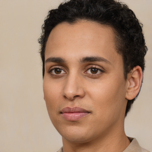 Joyful latino young-adult male with short  brown hair and brown eyes