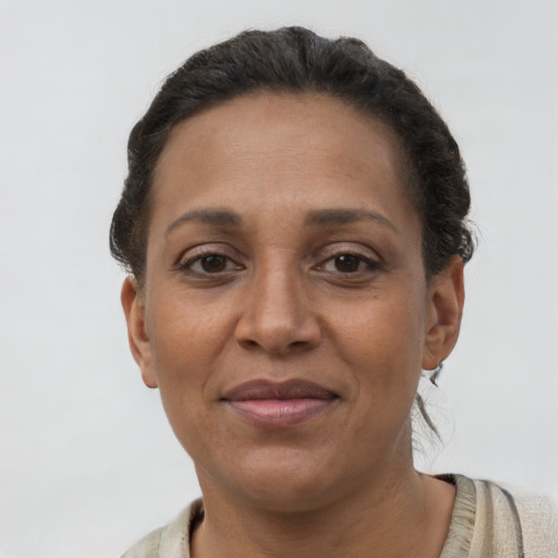 Joyful latino adult female with short  brown hair and brown eyes