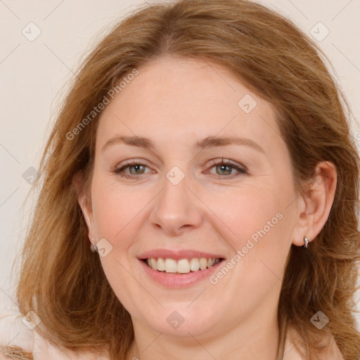 Joyful white adult female with long  brown hair and grey eyes