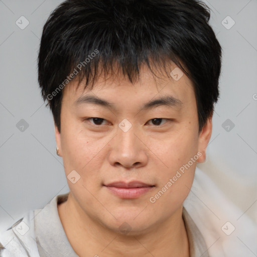 Joyful asian young-adult male with short  brown hair and brown eyes