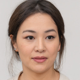 Joyful asian young-adult female with medium  brown hair and brown eyes