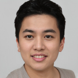 Joyful asian young-adult male with short  brown hair and brown eyes