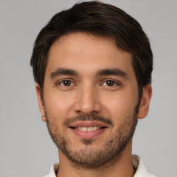 Joyful white young-adult male with short  brown hair and brown eyes