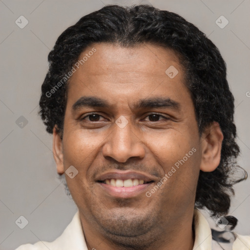 Joyful latino adult male with short  brown hair and brown eyes