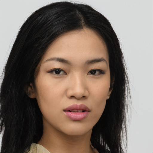 Joyful asian young-adult female with long  black hair and brown eyes