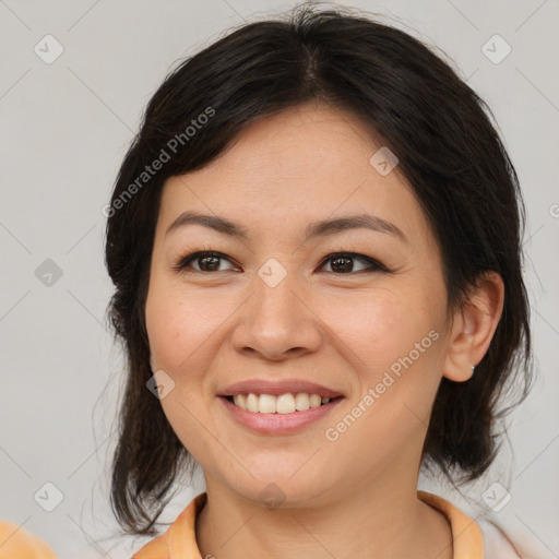 Joyful asian young-adult female with medium  brown hair and brown eyes