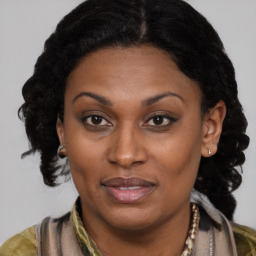 Joyful black adult female with medium  brown hair and brown eyes