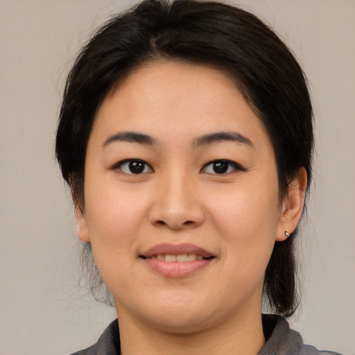 Joyful asian young-adult female with medium  brown hair and brown eyes