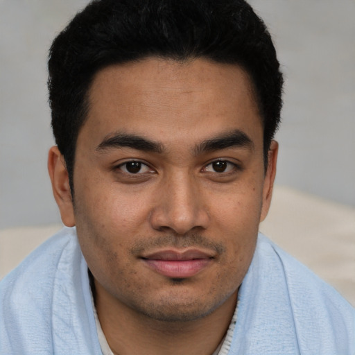 Joyful asian young-adult male with short  black hair and brown eyes