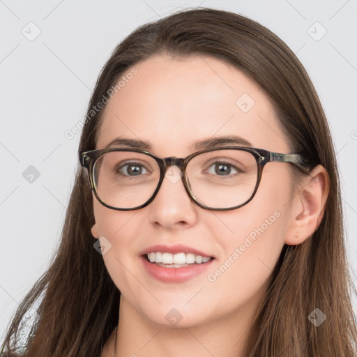 Joyful white young-adult female with long  brown hair and blue eyes