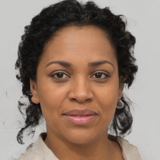 Joyful black adult female with medium  brown hair and brown eyes