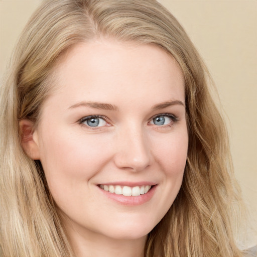 Joyful white young-adult female with long  brown hair and blue eyes