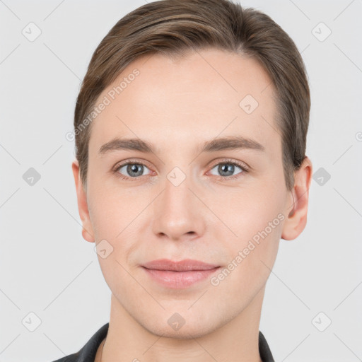 Joyful white young-adult male with short  brown hair and grey eyes