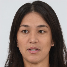 Joyful asian adult female with long  brown hair and brown eyes