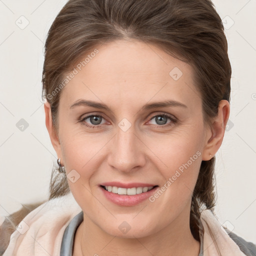 Joyful white young-adult female with medium  brown hair and grey eyes